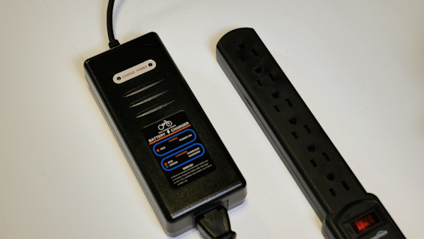 A Rad Power Bikes battery charger is plugged infa3122385 2 1