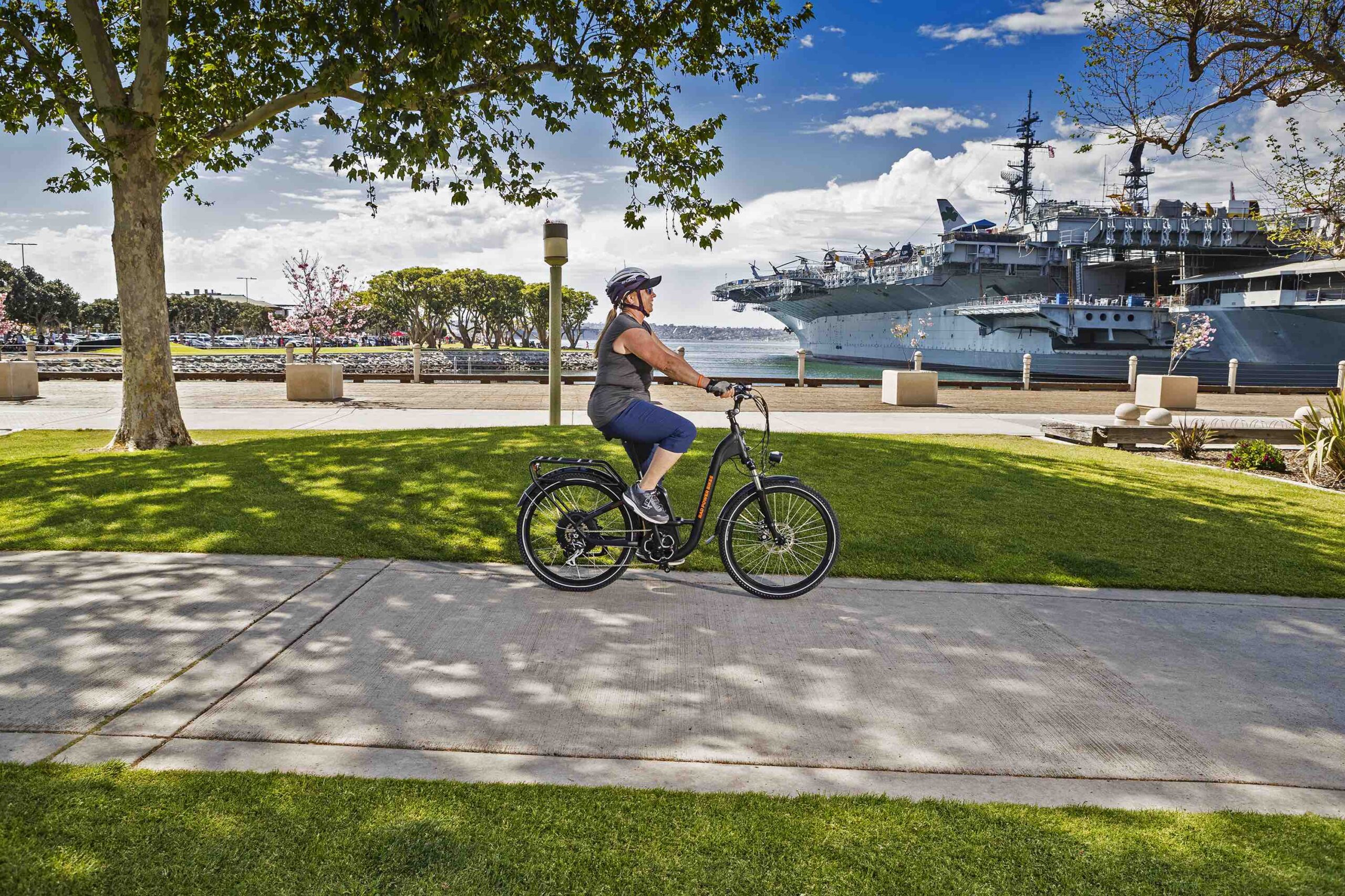 A woman rides a RadCity Step-Thru electric commuter bike in San Diego.