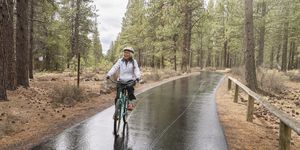 biking in the rain active mixed race senior woman on relaxing bike ride